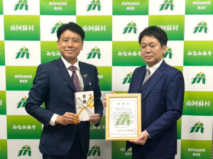 贈呈式での南阿蘇村太田村長と宮崎健太郎社長